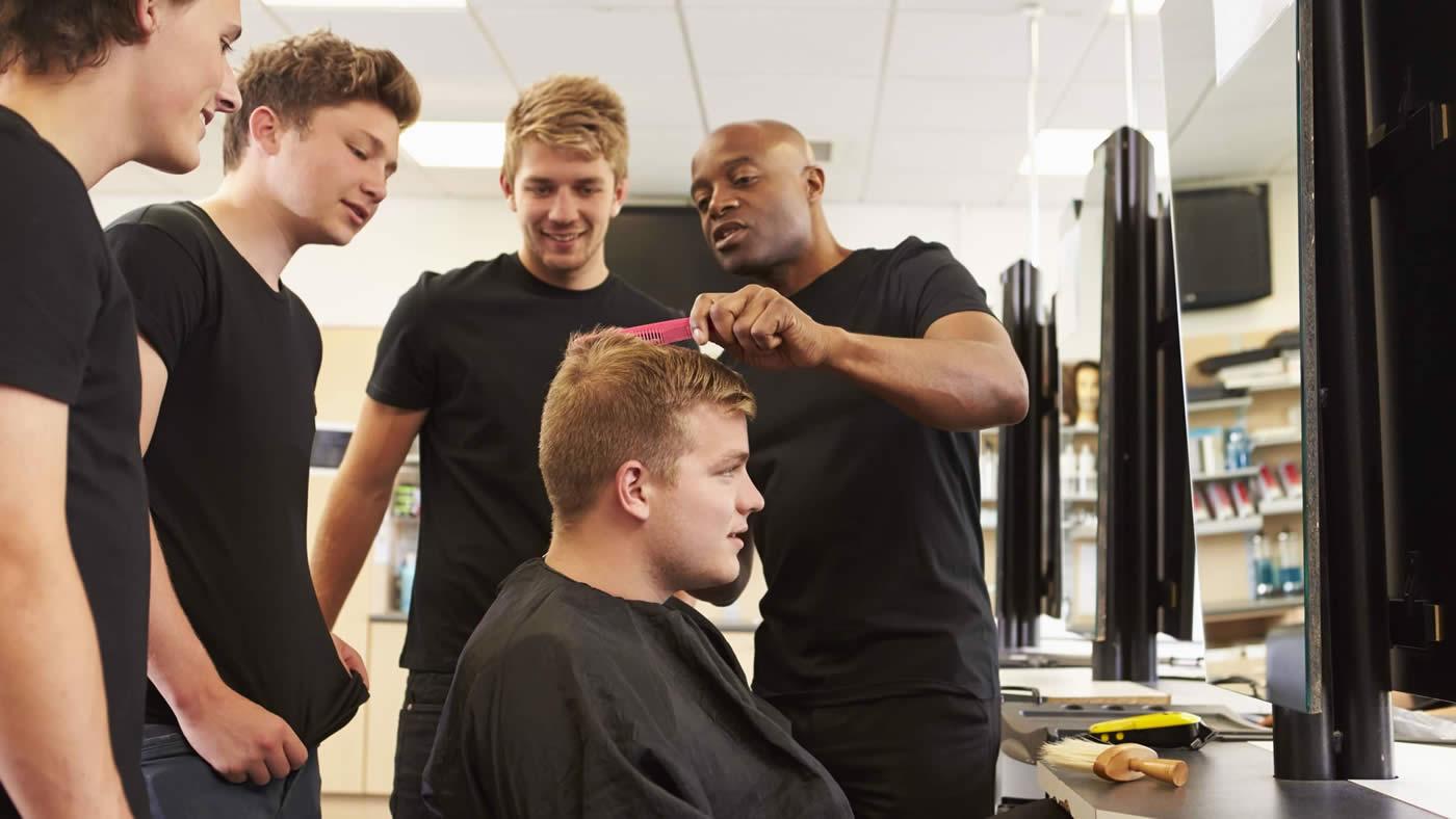 Hairdresser training students with live model