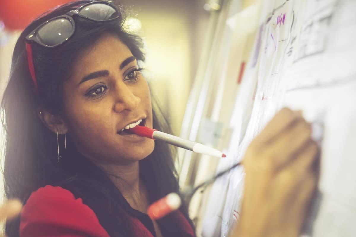 Woman working on whiteboard
