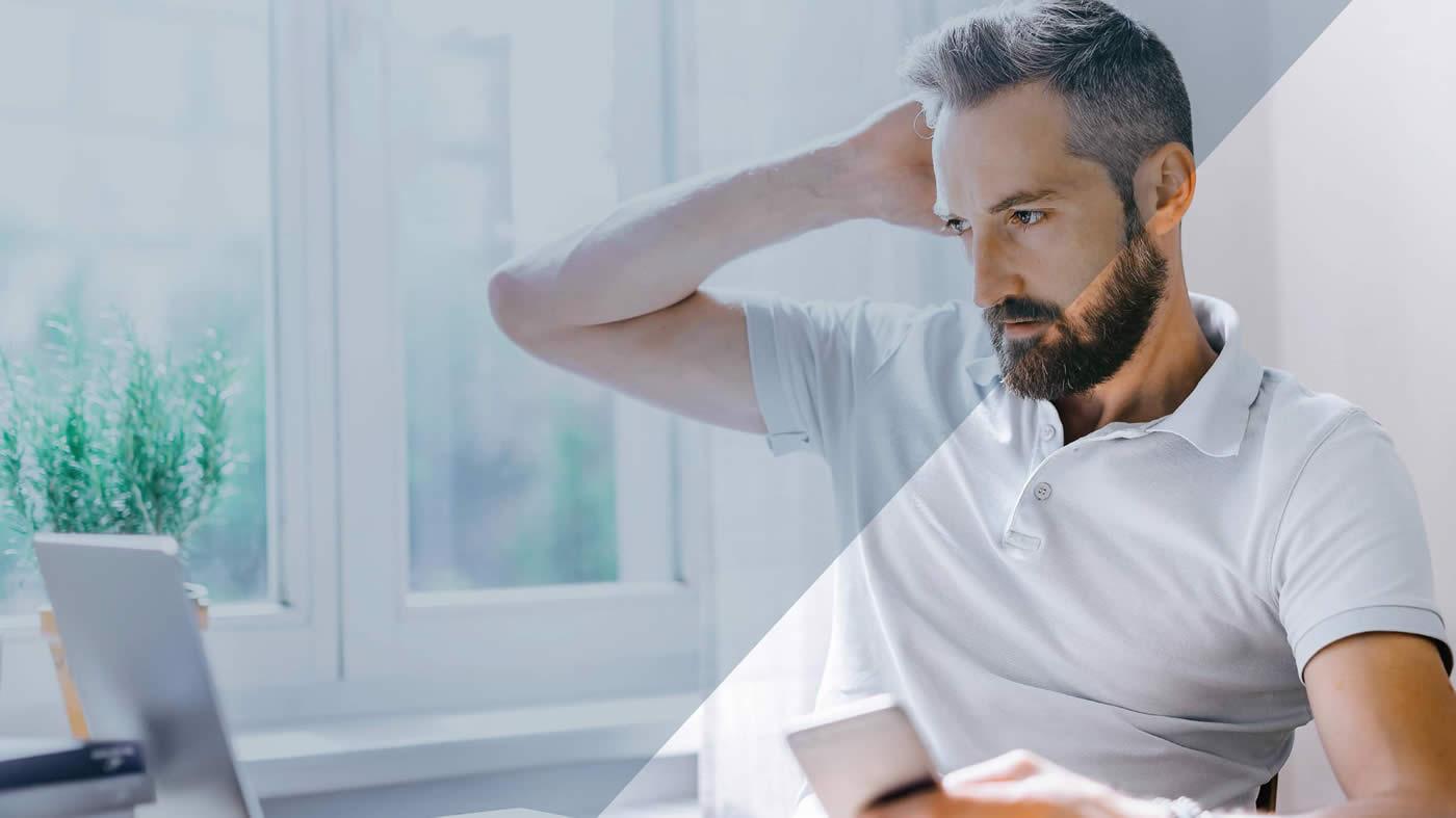 Man on laptop looking concerned