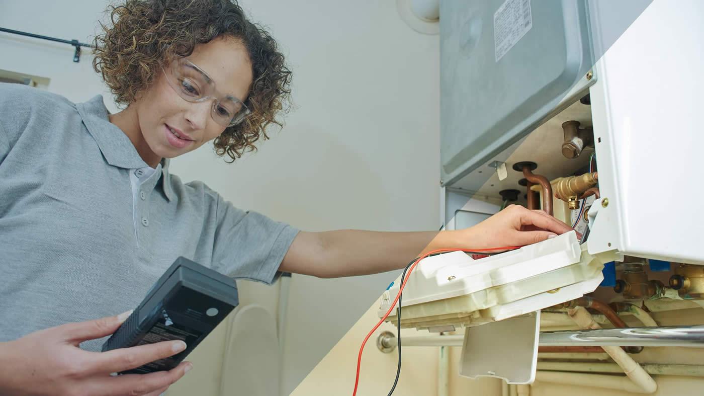 Women working on a boiler