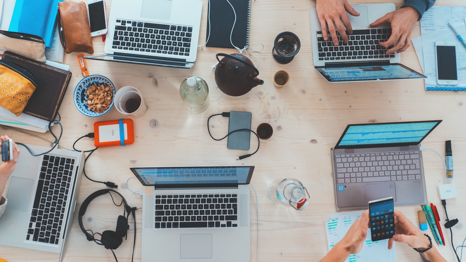 Desk with people working on laptops