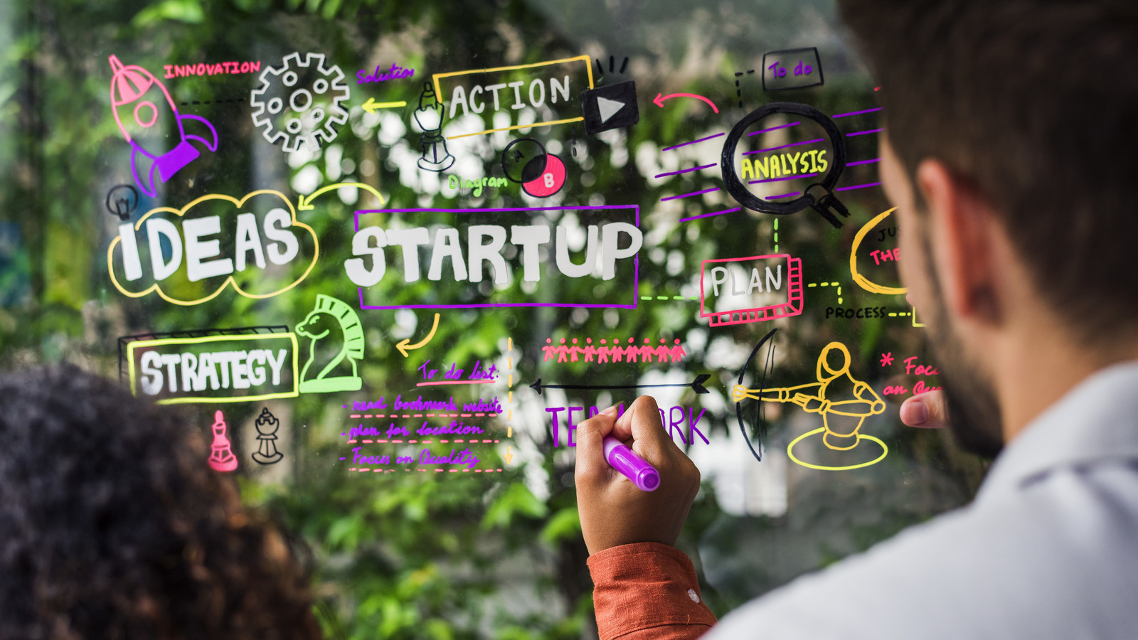 Brainstorming startup ideas on a window