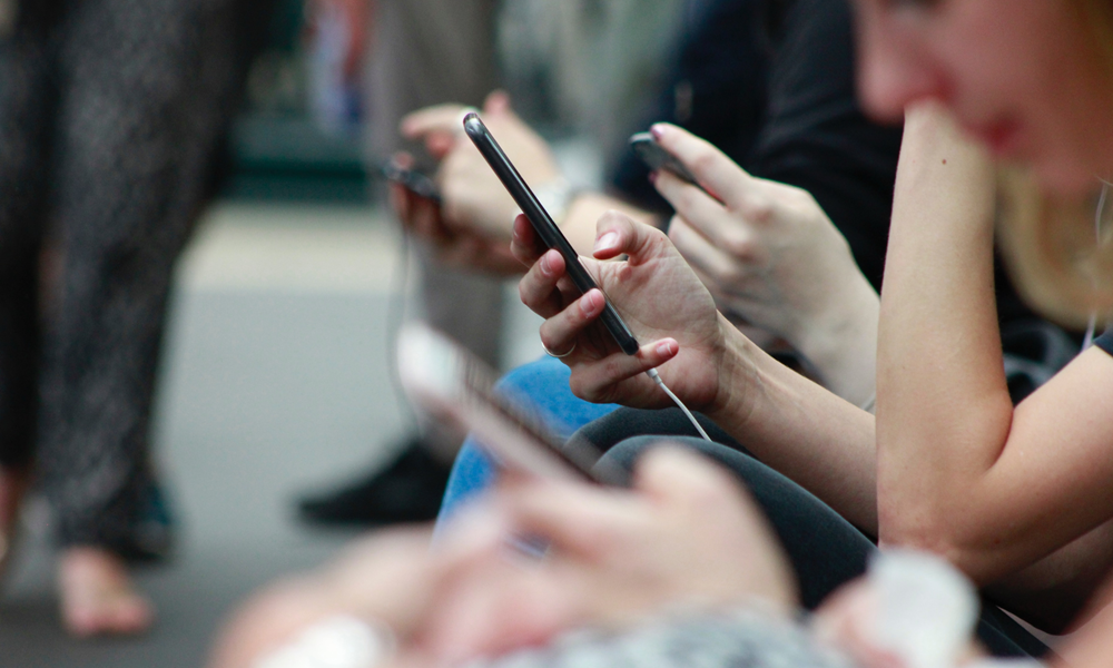 Row of people on smartphones