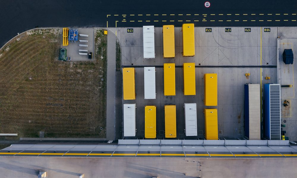 Aerial view of lorries parked outside factory