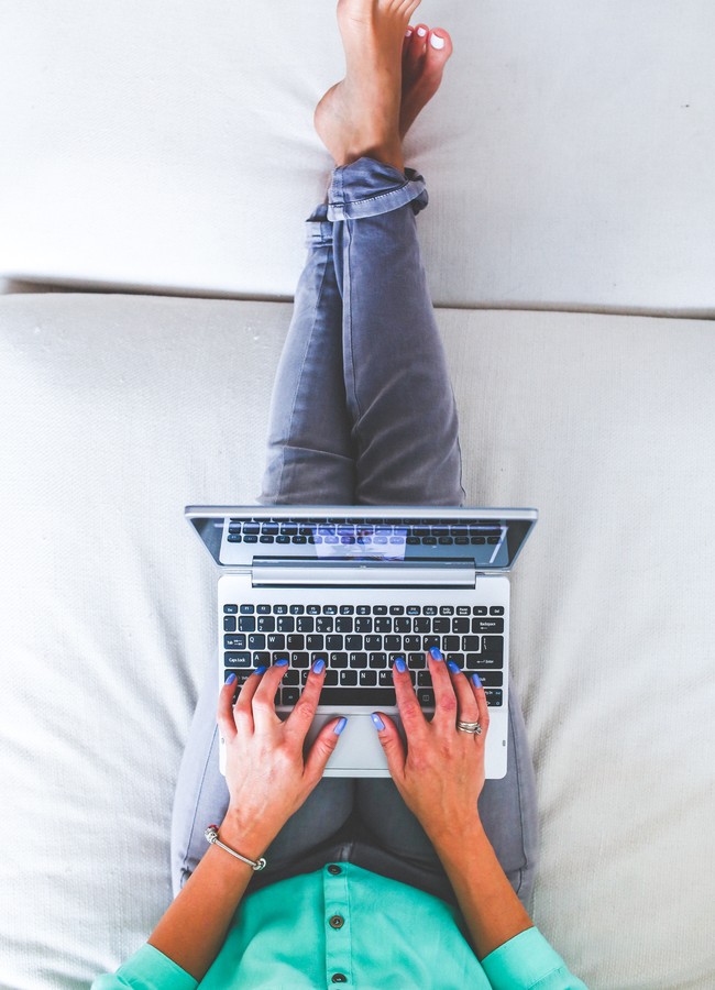 Lying down on bed on laptop