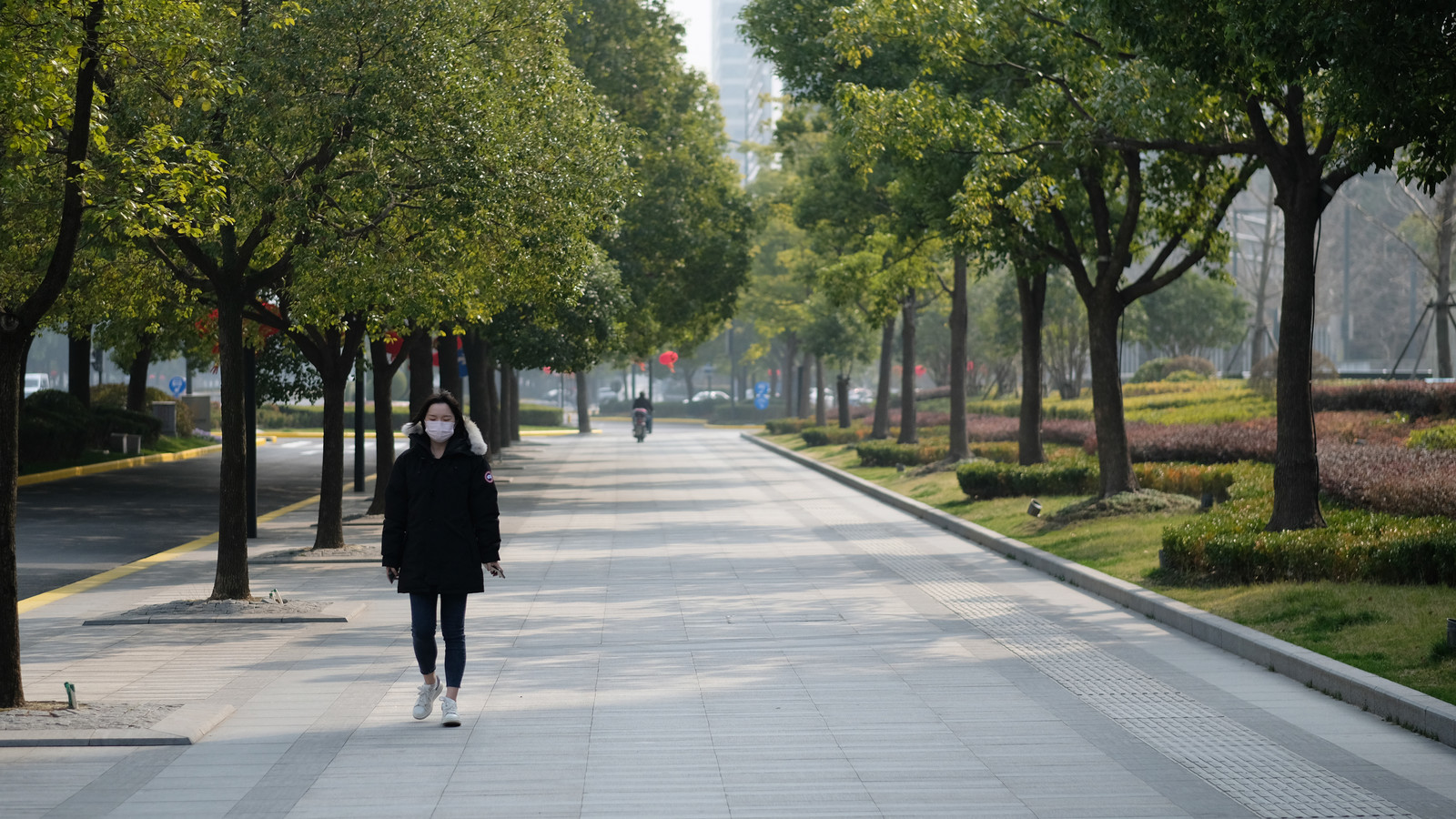 People wearing surgical mask walking on street in Shanghai
