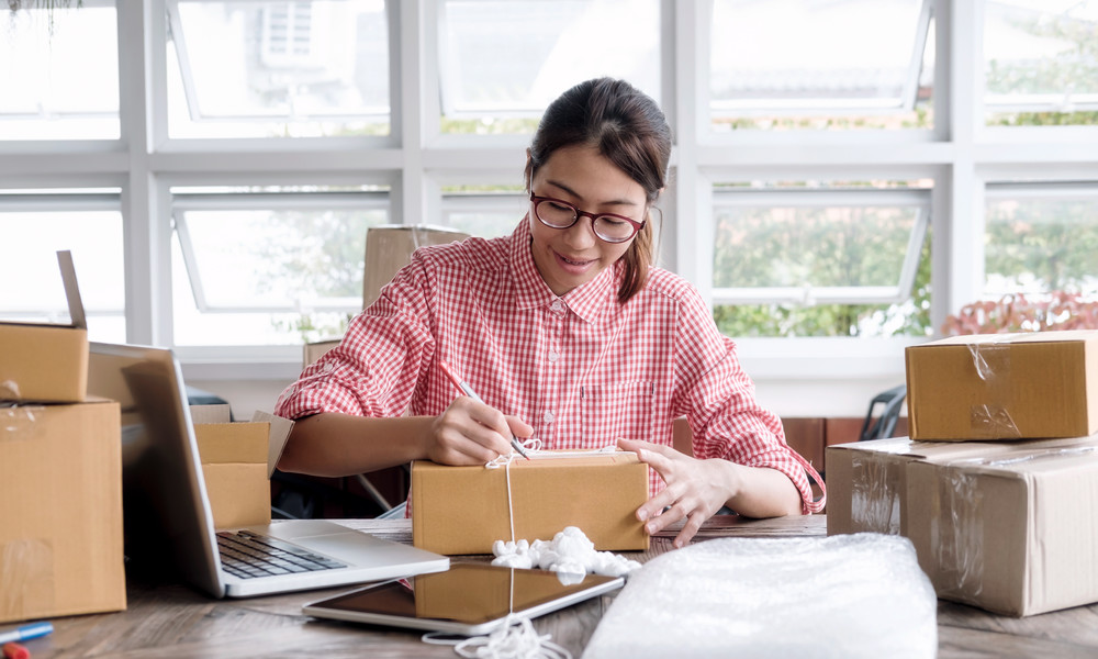 Young startup entrepreneur small business owner working at home, packaging and delivery situation.