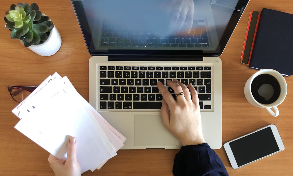 Woman working on laptop top view