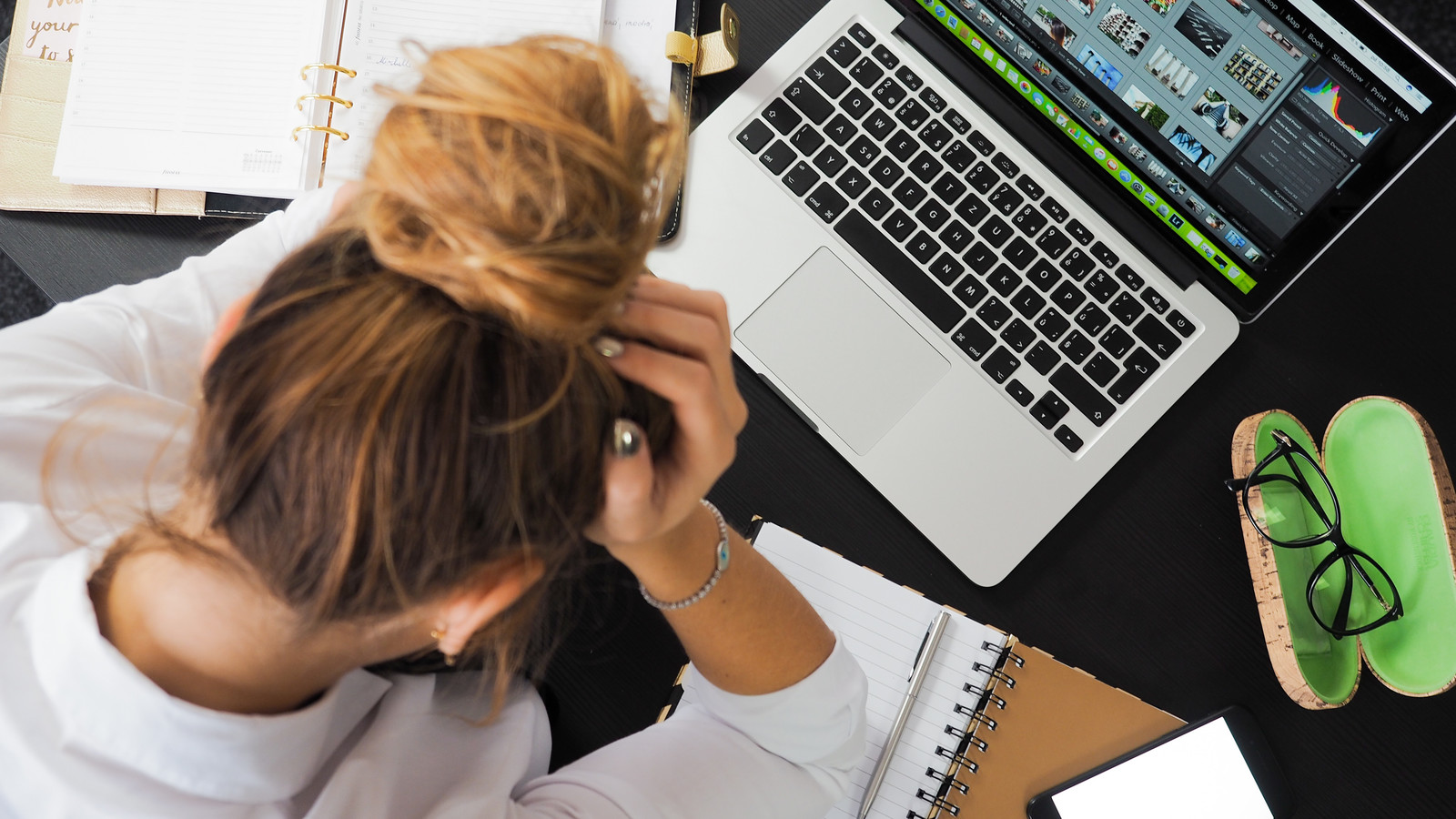 Women stressed next to computer