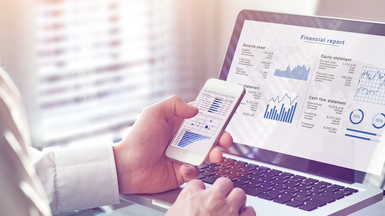 Accountant working on consolidated financial report of corporate operations, consultant auditing finance data (balance sheet, income statement) on screen with business charts, fintech, manager