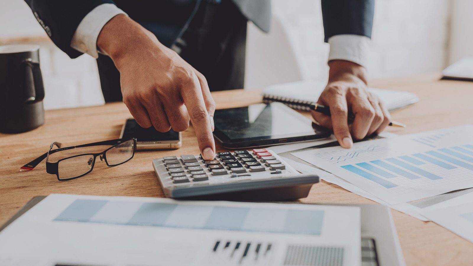 Businesspeople discussing the charts and graphs,businessmen discussing on stockmarket document in office,Business concept.